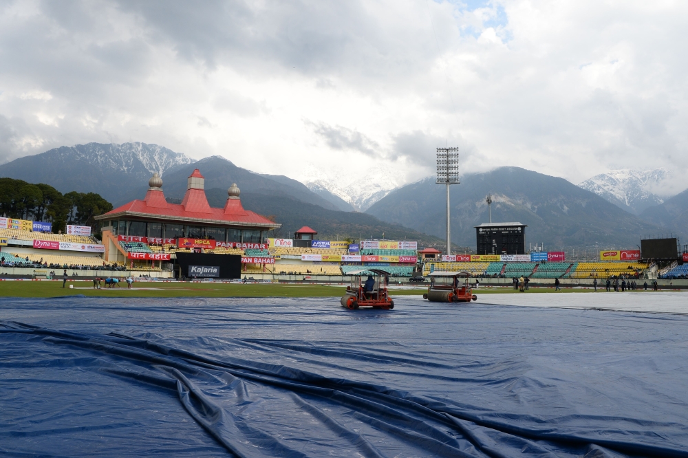 Ground staff work on the pitch ahead of the start of first one day international (ODI) cricket match of a three match series between India and South Africa, at the Himachal Pradesh Cricket Association Stadium in Dharamsala on March 12, 2020. 
/ AFP / Saj