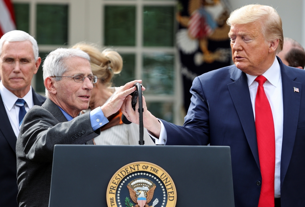 US President Donald Trump introduces National Institute of Allergy and Infectious Diseases Director Anthony Fauci as Vice President Mike Pence looks on after Trump declared the coronavirus pandemic a national emergency during a news conference in the Rose