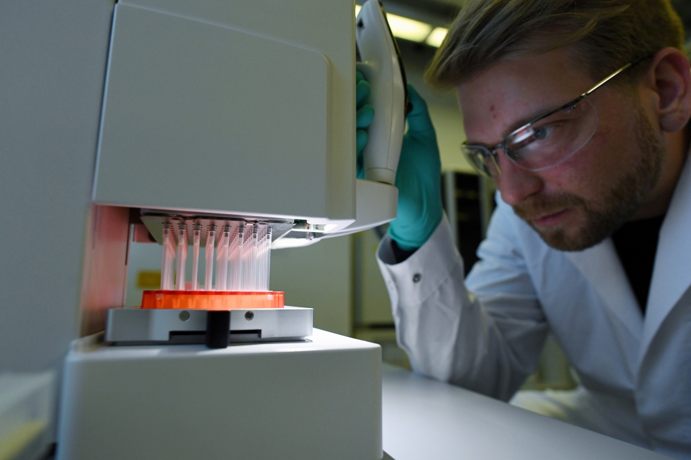 Employee Philipp Hoffmann, of German biopharmaceutical company CureVac, demonstrates research workflow on a vaccine for the coronavirus (COVID-19) disease at a laboratory in Tuebingen, Germany, March 12, 2020. Reuters/Andreas Gebert