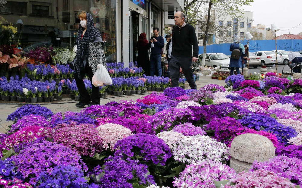 Iranians, some wearing protective face masks, shop for traditional items ahead of Nowruz, the national New Year 2-week celebration, at the Tajrish Bazaar in the capital Tehran on March 19, 2020, despite the heavy death toll due to infections by the novel 
