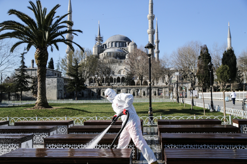 :ISTANBUL, TURKEY - MARCH 21: Health officials carry out disinfecting works at Sultanahmet Square as a precaution against coronavirus (Covid-19) pandemic in Istanbul, Turkey on March 21, 2020. ( Elif Öztürk - Anadolu Agency )