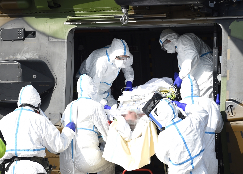Medical staff install a patient aboard a French medical helicopter NH90 of the 1st RHC near Mercy hospital (CHR Metz), eastern France, to be evacuated to a German hospital in Essen, on March 28, 2020, amid the outbreak of the COVID-19 caused by the novel 