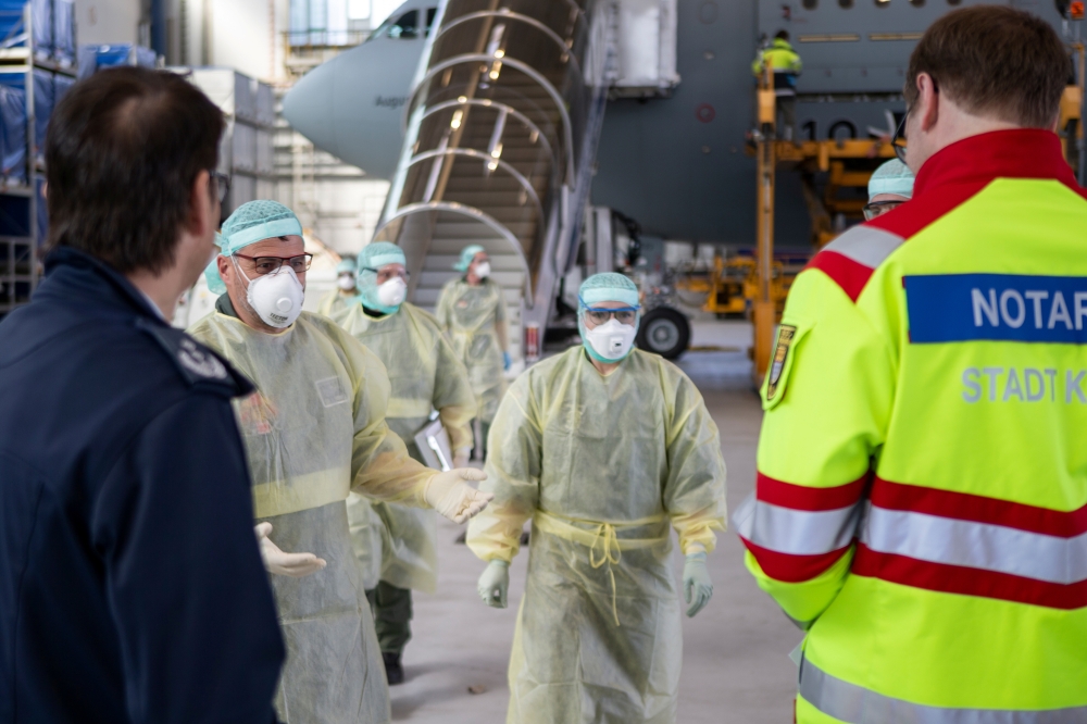 A Bundeswehr handout photo shows staff in protective suits leaving the German air force Airbus A-310 