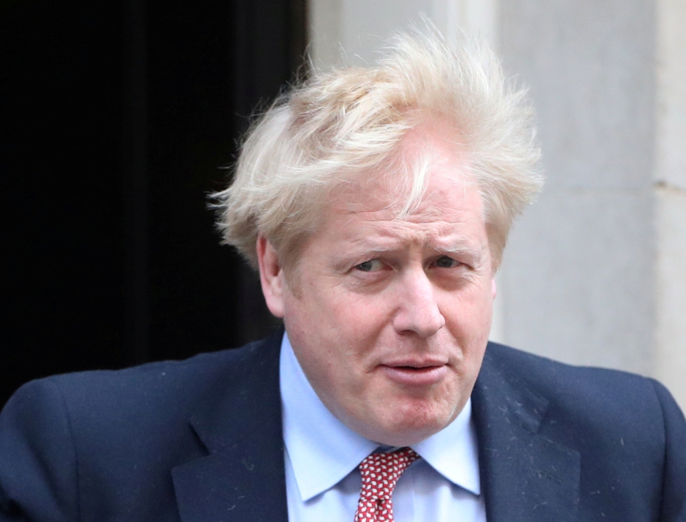 FILE PHOTO: Britain's Prime Minister Boris Johnson leaves Downing Street, as the spread of coronavirus disease (COVID-19) continues. London, Britain, March 25, 2020. REUTERS/Hannah Mckay/File Photo