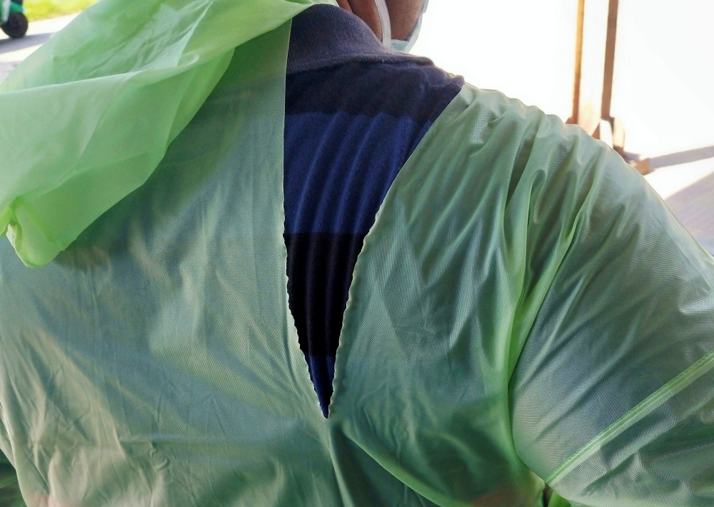 A doctor wearing a torn raincoat stands at the major coronavirus disease (COVID-19) treatment facility amid concerns about the spread of the disease in Kolkata, India, March 26, 2020. Picture taken March 26, 2020. REUTERS/Stringer