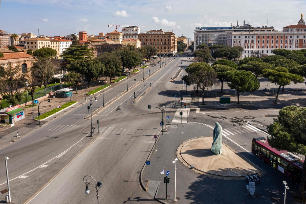 A morning aerial photo taken on March 30, 2020 shows a deserted Via Enrico de Nicola and a statue of late Pope Johan Paul II (Bottom R) near the Termini railway station in Rome during the country's lockdown aimed at curbing the spread of the COVID-19 infe