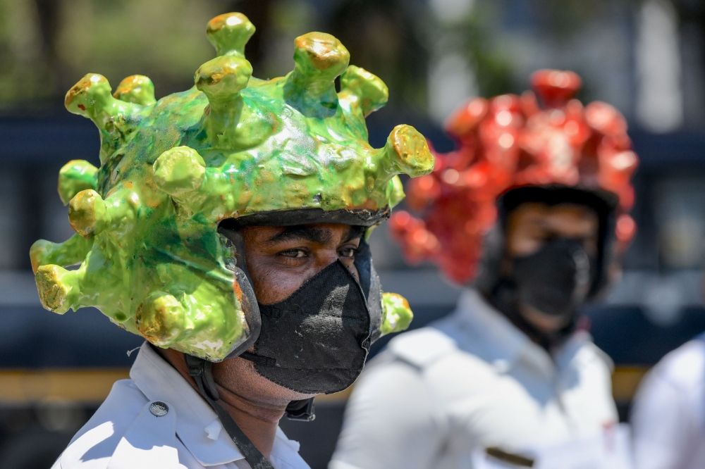Traffic policemen wearing coronavirus-themed helmets in a campaign to educate the public during lockdown against the COVID-19 in Bangalore on March 31, 2020. AFP / Manjunath Kiran