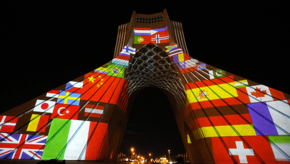 Iran's Azadi (Freedom) Tower is lit up with flags and messages of hope in solidarity with all the countries affected by the COVID-19 coronavirus pandemic, in Tehran on March 31, 2020. / AFP /
