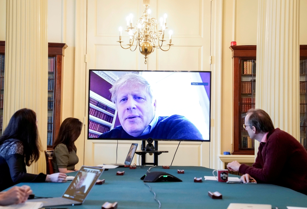 Britain's Prime Minister Boris Johnson appears on a monitor for the coronavirus disease (COVID-19) meeting in London, Britain March 28, 2020 Andrew Parsons/10 Downing Street/Handout via REUTERS