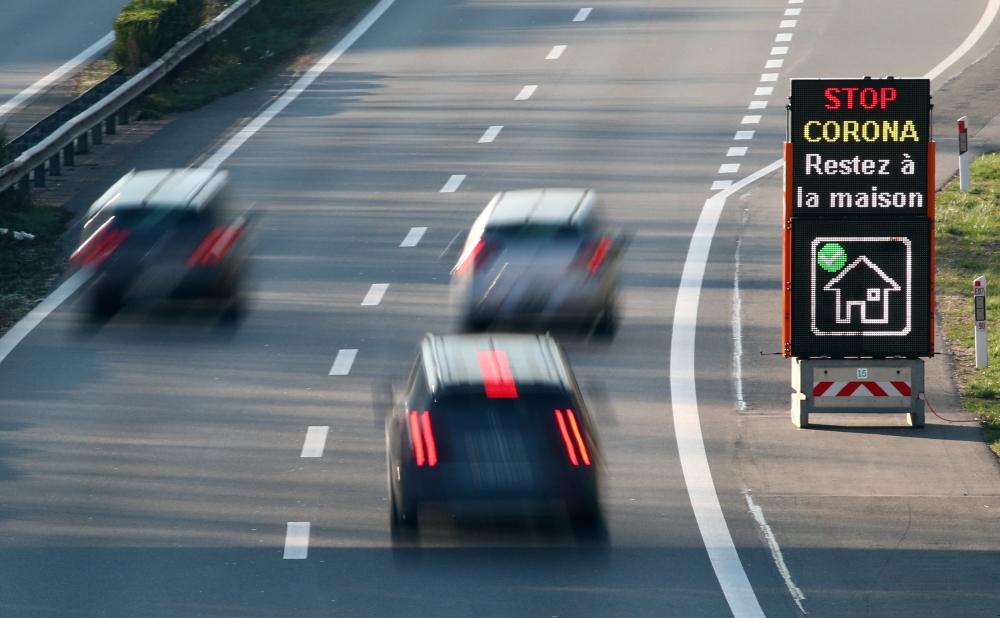Cars drive past an information sign on the motorway ahead of the Easter weekend during the coronavirus disease (COVID-19) outbreak in Lausanne, Switzerland, April 8, 2020. The board reads : 