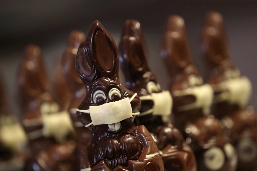 Chocolate Easter bunnies wearing protective masks are seen in the workshop of Belgian artisan chocolate maker Genevieve Trepant, during the coronavirus disease (COVID-19) outbreak in Lonzee, Belgium April 10, 2020. REUTERS/Yves Herman