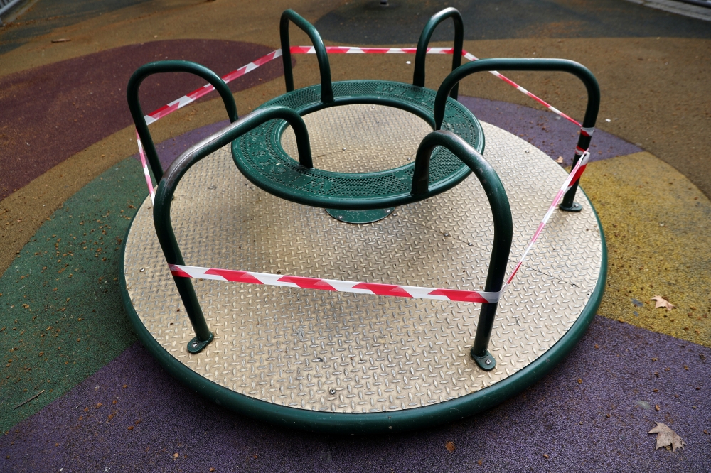:A children's merry-go-round is seen cordoned off during lockdown amid the coronavirus disease (COVID-19) outbreak, in Madrid, Spain, March 22, 2020. Picture taken March 22, 2020. REUTERS/Susana vera