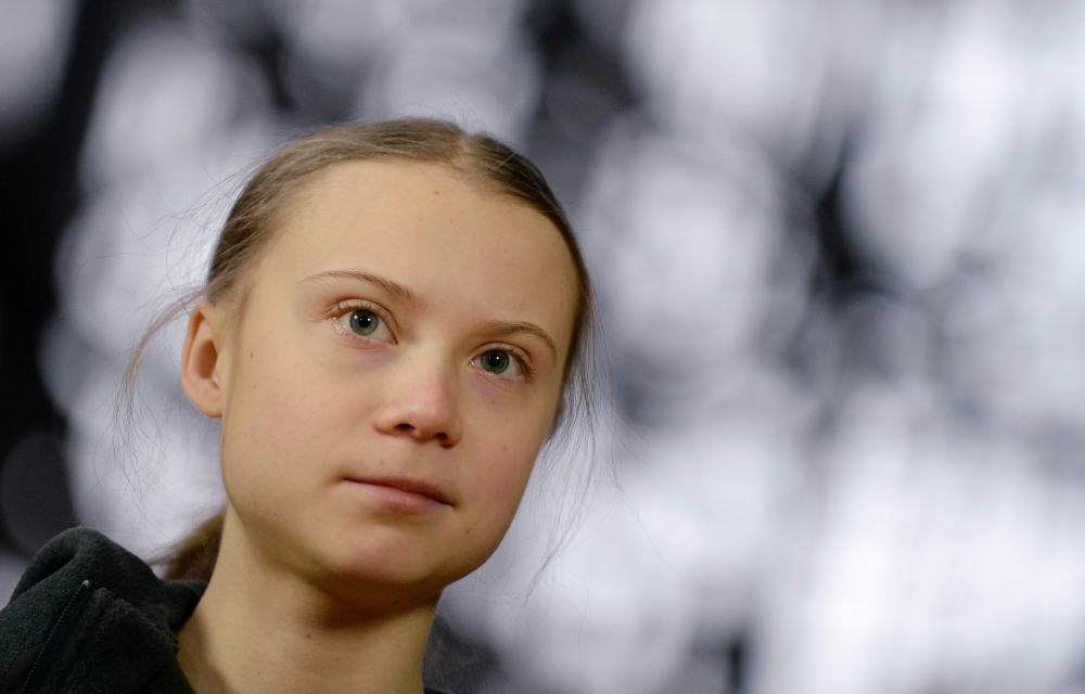 FILE PHOTO: Swedish climate activist Greta Thunberg talks to the media before meeting with EU environment ministers in Brussels, Belgium, March 5, 2020. REUTERS/Johanna Geron/File Photo
 