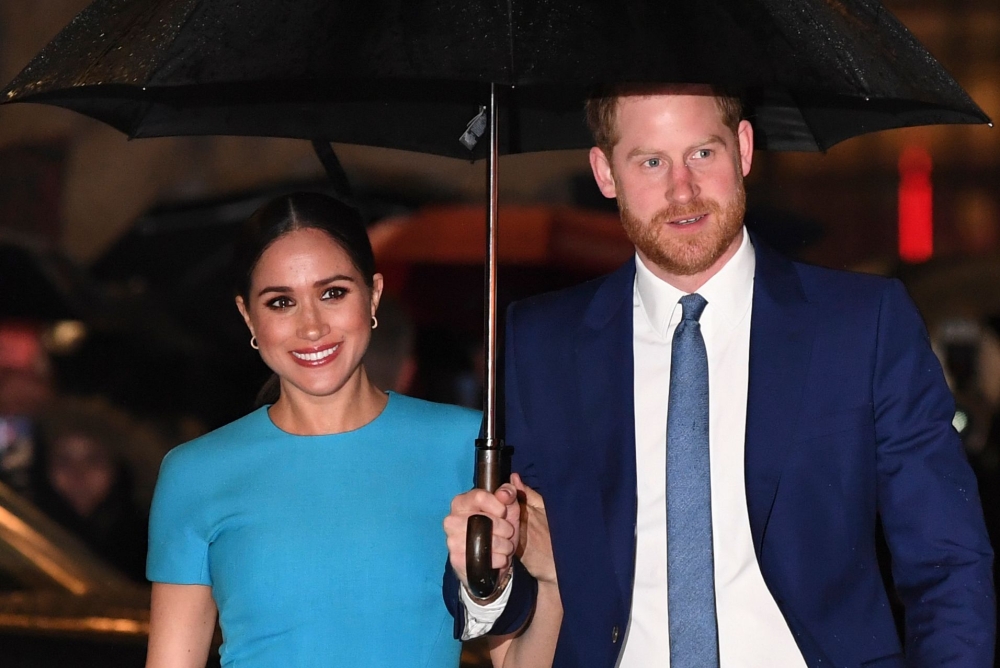 (FILES) In this file photo taken on March 05, 2020 Britain's Prince Harry, Duke of Sussex (R) and Meghan, Duchess of Sussex arrive to attend the Endeavour Fund Awards at Mansion House in London. / AFP / DANIEL LEAL-OLIVAS
