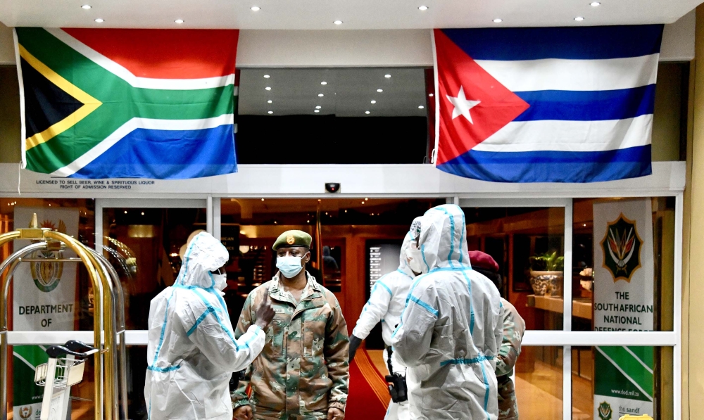 This hand out photo taken and released by GCIS on April 27, 2020, shows Cuban Health Specialists arriving at the Waterkloof Air Force Base in Pretoria, South Africa, to support efforts to curb the spread of the COVID-19 coronavirus. 