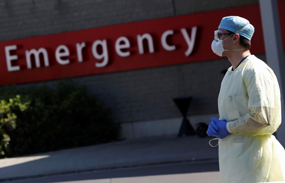 A member of the medical personnel stands at the entrance of the emergency unit at CHIREC Delta Hospital as the spread of the coronavirus disease (COVID-19) continues in Brussels, Belgium April 25, 2020. REUTERS/Yves Herman
