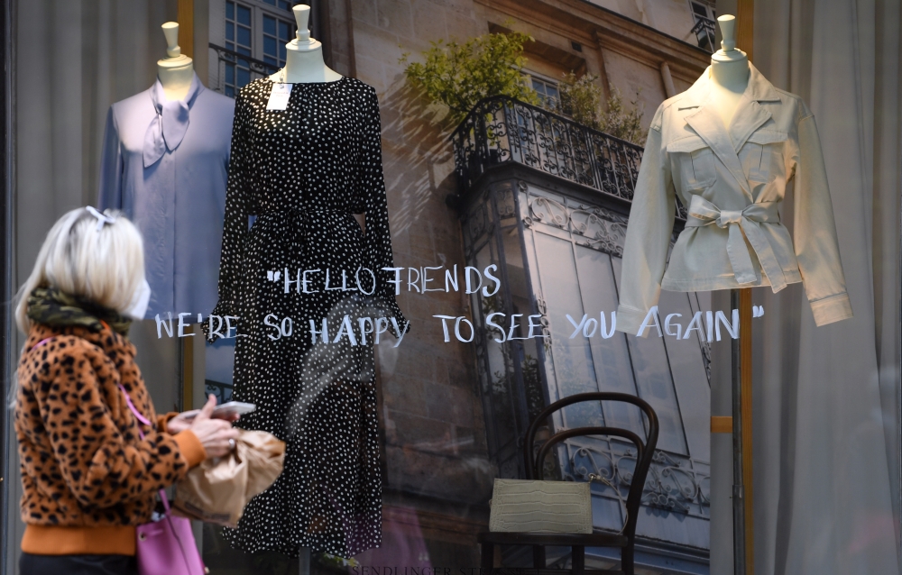 A woman with protective mask walks through the city, as the spread of the coronavirus disease (COVID-19) continues in Munich, Germany, April 27, 2020. REUTERS/Andreas Gebert
