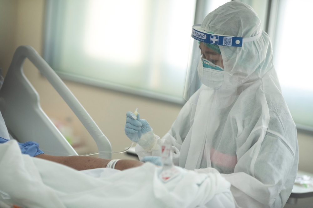 Nurse Tatsanee Onthong, 26, wears personal protective equipment (PPE) as she attends to a COVID-19 in the Emerging Infectious Disease Clinic intensive care unit at King Chulalongkorn Memorial Hospital in Bangkok, Thailand, April 22, 2020. Picture taken Ap
