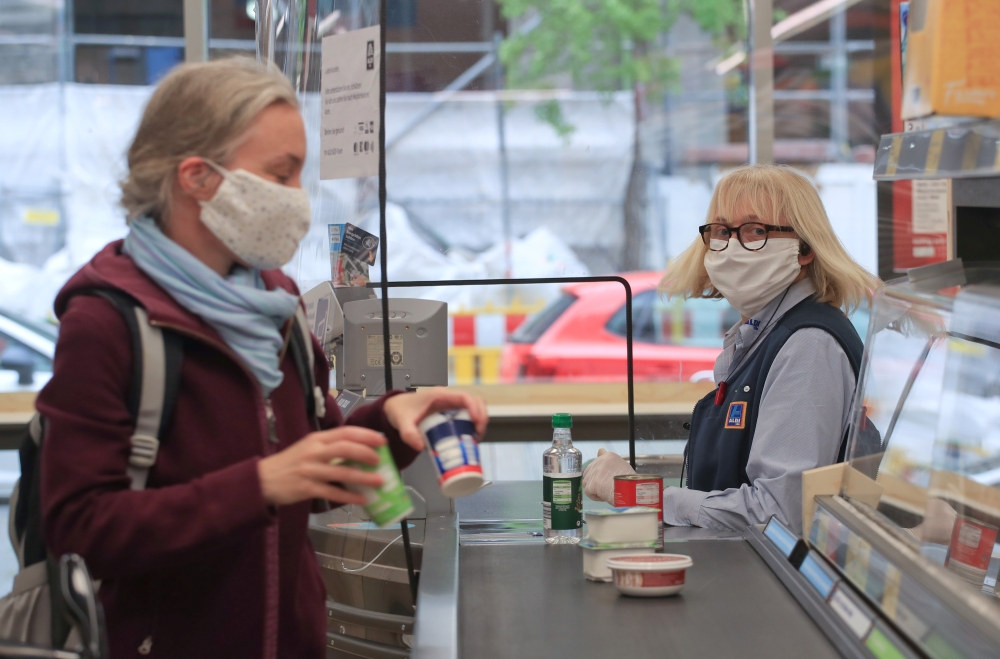 A customer at the food discounter ALDI is wearing a protective mask, as the spread of coronavirus disease (COVID-19) continues in Duesseldorf, Germany, April 29, 2020. REUTERS/Wolfgang Rattay