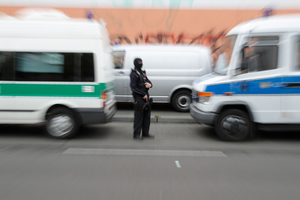 A police officer stands in front of the Al-Irschad Mosque during a raid on April 30, 2020 in Berlin, as dozens of police and special forces stormed mosques and associations linked to Hezbollah in Bremen, Berlin, Dortmund and Muenster in the early hours of