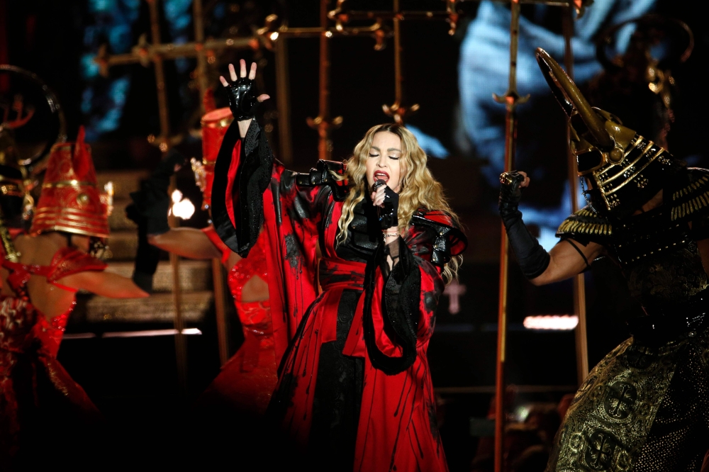 (FILES) In this file photograph taken on December 9, 2015, US singer Madonna performs during a concert at The AccorHotels Arena in Paris. Madonna said May 7, 2020, that she has had the coronavirus and that it was why she had to cancel a concert in Paris i