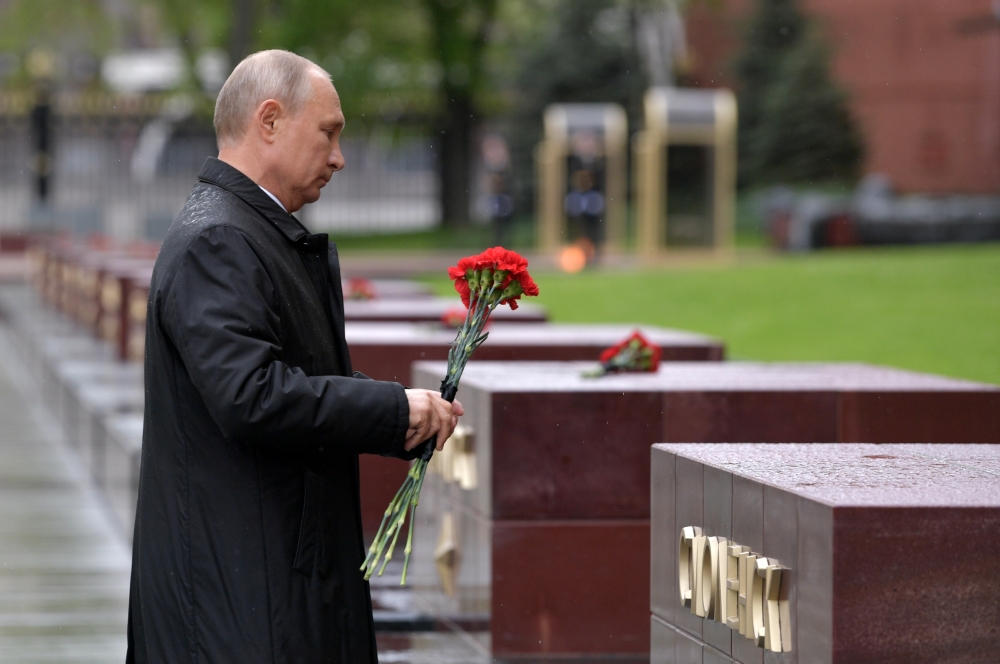 Russian President Vladimir Putin lays flowers at a memorial to the Hero Cities during a ceremony at the Tomb of the Unknown Soldier on Victory Day, which marks the anniversary of the victory over Nazi Germany in World War Two, amid the outbreak of the cor