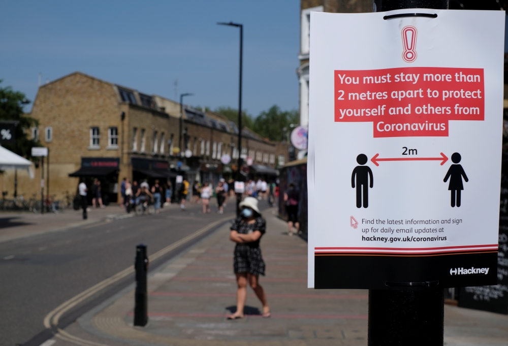 A social distancing sign is seen on Broadway Market, following the outbreak of the coronavirus disease (COVID-19), London, Britain, May 9, 2020. REUTERS/John Sibley