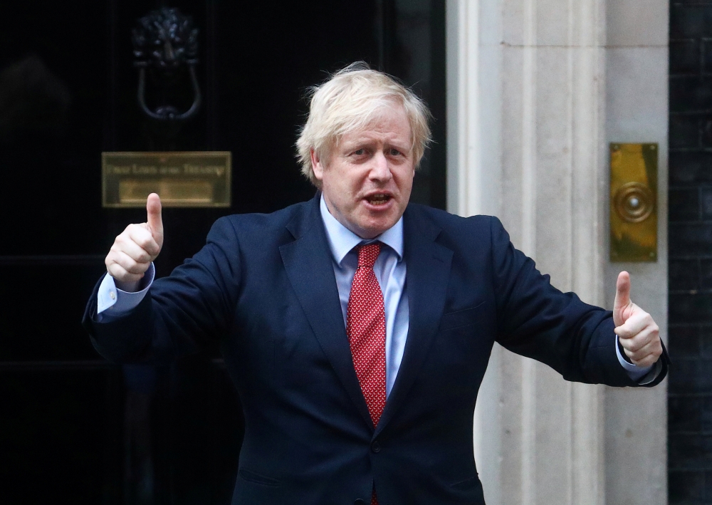 Britain's Prime Minister Boris Johnson reacts outside 10 Downing Street during the Clap for our Carers campaign in support of the NHS, following the outbreak of the coronavirus disease (COVID-19), London, Britain, May 7, 2020. Reuters/Hannah McKay/File Ph