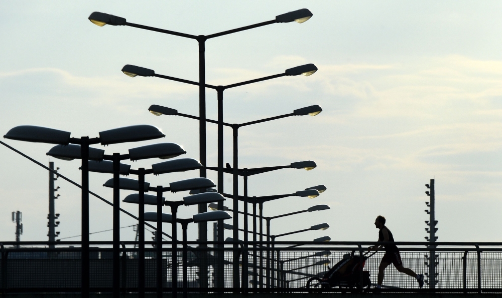 A man runs at a bridge near the Olympic park in Munich, southern Germany, on May 9, 2020, amid the novel coronavirus Covid-19 pandemic. / AFP / Christof Stache 