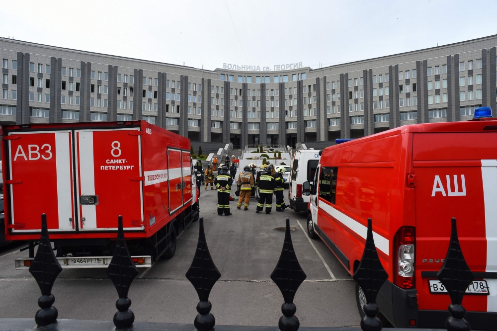 Emergencies personnel work at the site of a fire at the Saint George hospital in Saint Petersburg on May 12, 2020. A fire at a hospital in Russia's second city Saint Petersburg on May 12 killed five coronavirus patients who had been attached to ventilator