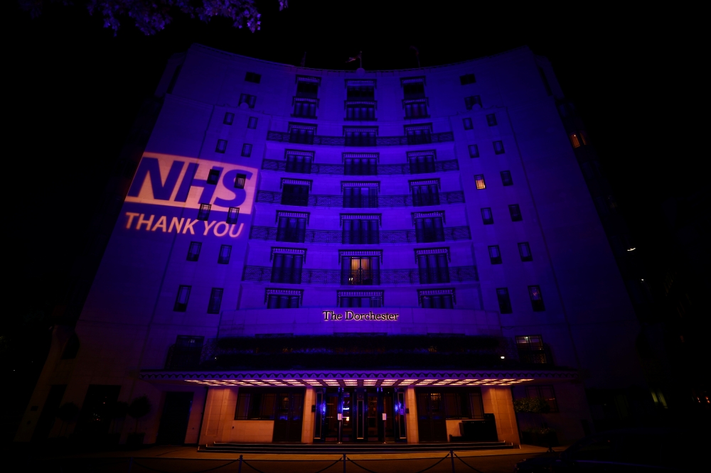 The Dorchester Hotel lit up in blue in support of the NHS, following the outbreak of the coronavirus disease (COVID-19), London, Britain, May 11, 2020. REUTERS/Hannah Mckay
