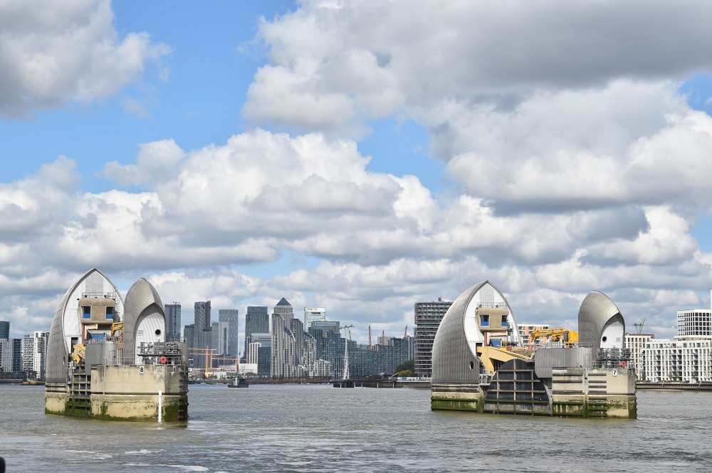The office buildings in the financial area of Canary Wharf in London are seen behind the Thames Barrier on May 14, 2020. Britain's economy shrank in the first quarter at the fastest pace since the 2008 financial crisis as the country went into lockdown ov