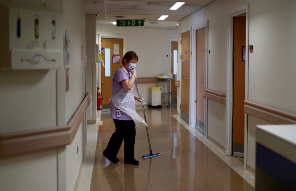 Domestic Jane Shackleton mops the floor on the Postnatal Ward at the Lancashire Women and Newborn Centre at Burnley General Hospital in East Lancashire, following the outbreak of the coronavirus disease (COVID-19), in Burnley, Britain, May 15, 2020. Pictu