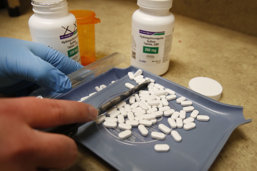 A pharmacy tech counts out pills of Hydroxychloroquine at Rock Canyon Pharmacy in Provo, Utah, on May 20, 2020. US President Donald Trump announced May 18 he has been taking hydroxychloroquine for almost two weeks as a preventative measure against COVID-1