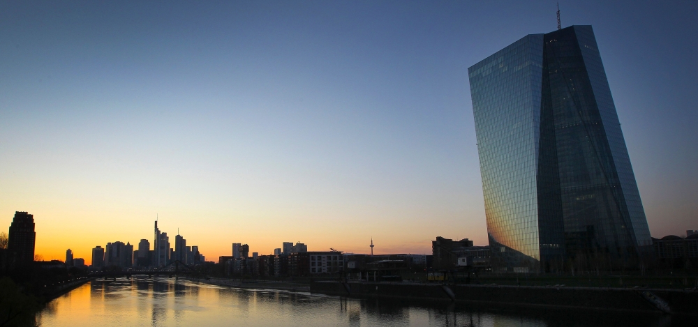 (FILES) This file photo taken on March 24, 2020 shows the sun setting behind the European Central Bank (ECB, R) and the city skyline in Frankfurt am Main, western Germany. / AFP / Daniel ROLAND