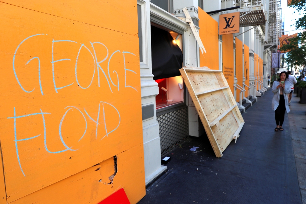 A message is seen painted on the exterior of the Louis Vuitton store after it was damaged by protesters after they participated in a march against the death in Minneapolis police custody of George Floyd, in the Manhattan borough of New York City, U.S., Ju
