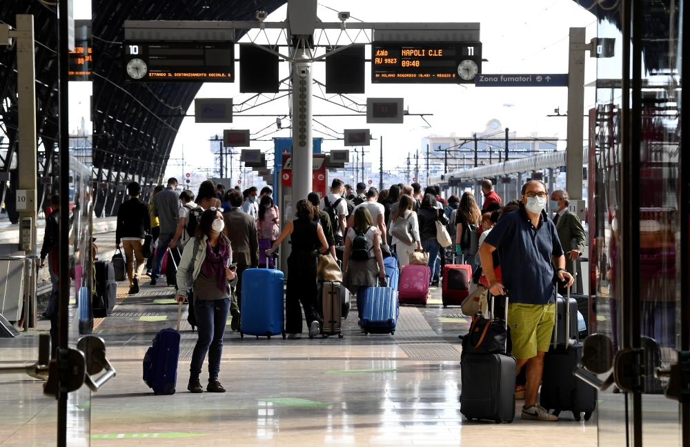 Commuters wearing protective face masks are seen at a platform at Milan central station, as Italy eases movement between regions as the country unwinds its rigid coronavirus disease (COVID-19) lockdown, in Milan, Italy June 3, 2020. REUTERS/Flavio Lo Scal