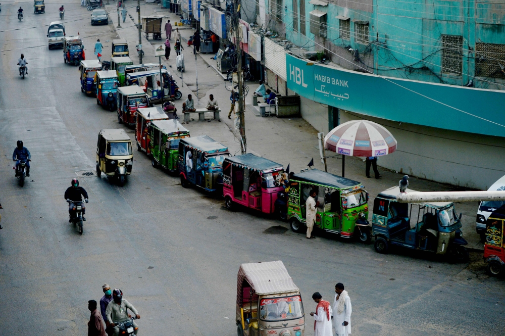Auto-rickshaws line up along roadside after the government resumed public transport services, in Pakistan's port city of Karachi on June 3, 2020. Pakistan's Prime Minister Imran Khan announced on June 1 his government would end several months of coronavir