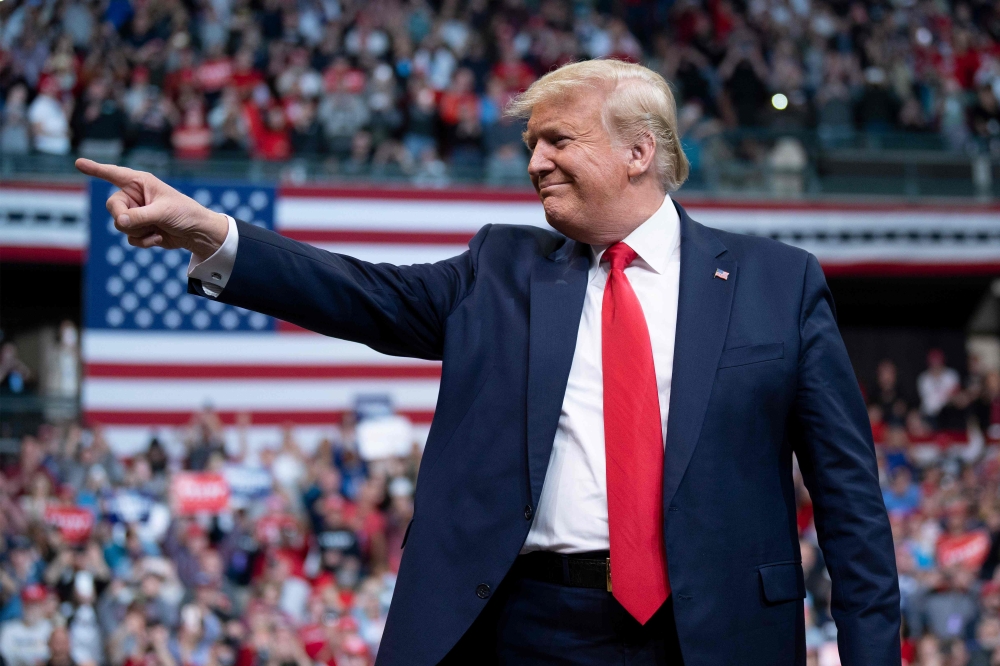 (FILES) In this file photo taken on February 10, 2020 US President Donald Trump gestures as he arrives to speak during a rally in Manchester, New Hampshire. / AFP / JIM WATSON