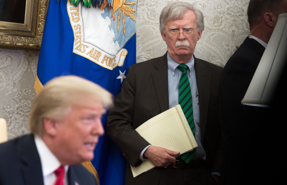 (FILES) In this file photo National Security Adviser John Bolton stands alongside US President Donald Trump as he speaks during a meeting with NATO Secretary General Jens Stoltenberg in the Oval Office of the White House in Washington, DC, May 17, 2018. A