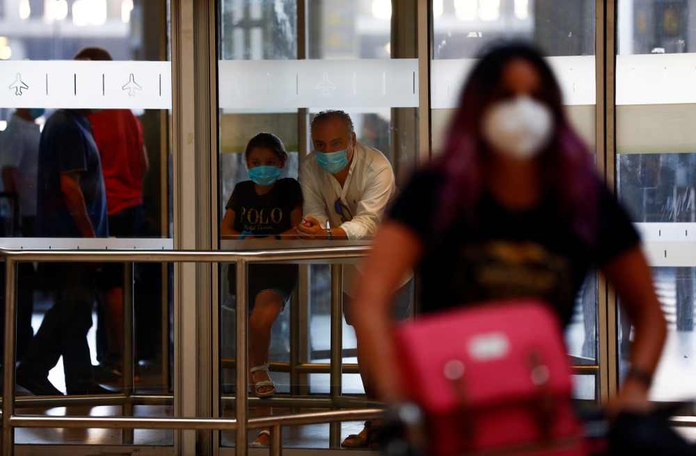 People wait for their family members at the arrivals area of the Adolfo Suarez Barajas airport, as Spain reopens its borders to visitors from most European countries after the coronavirus lockdown, in Madrid, Spain, June 22, 2020. REUTERS/Susana Vera