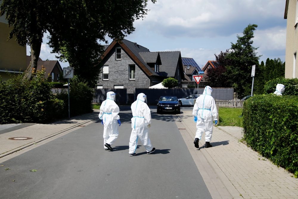 Members of a mobile testing unit of the German Army and German Red Cross arrive to test residents for the coronavirus disease (COVID-19), following an outbreak of the disease at Toennies meat factory, where employees remain under lockdown, in Guetersloh, 