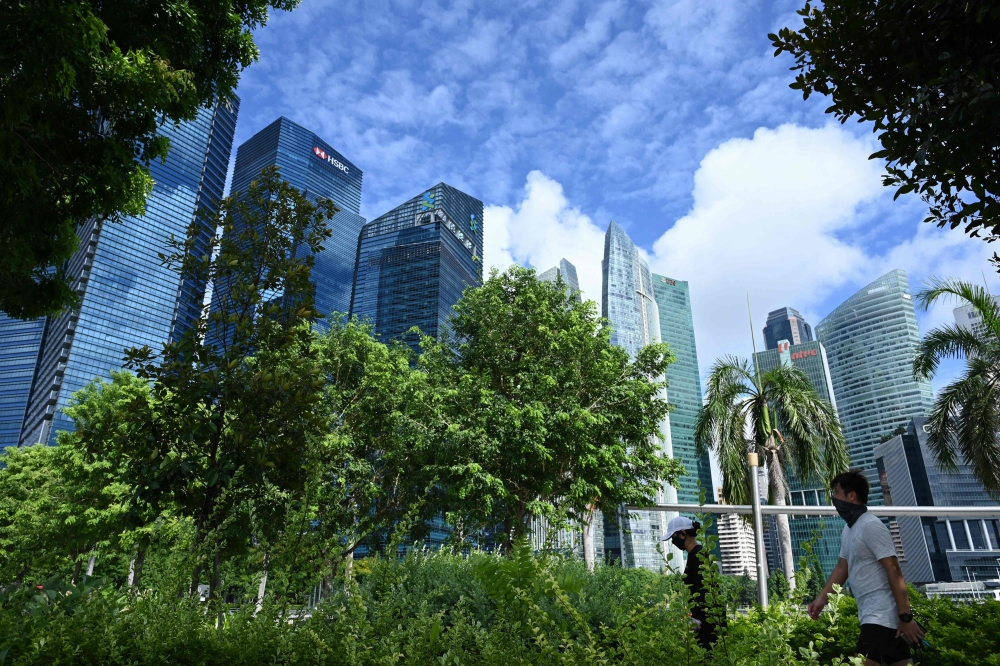 People exercise along the promenade at Marina Bay in Singapore on June 19, 2020, as restrictions to prevent the spread of the COVID-19 novel coronavirus are eased. AFP / Roslan Rahman 