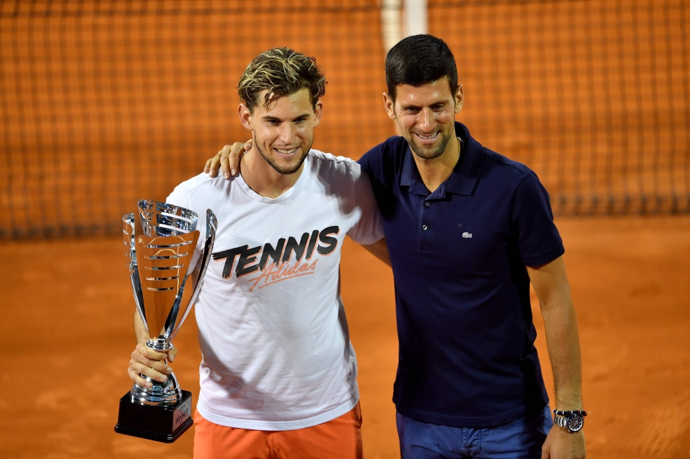 (FILES) In this file photo taken on June 14, 2020 Austrian tennis player Dominic Thiem poses for a photo with Serbian tennis player Novak Djokovic after winning the final match against Serbian tennis player Filip Krajinovic at the Adria Tour, Novak Djokov