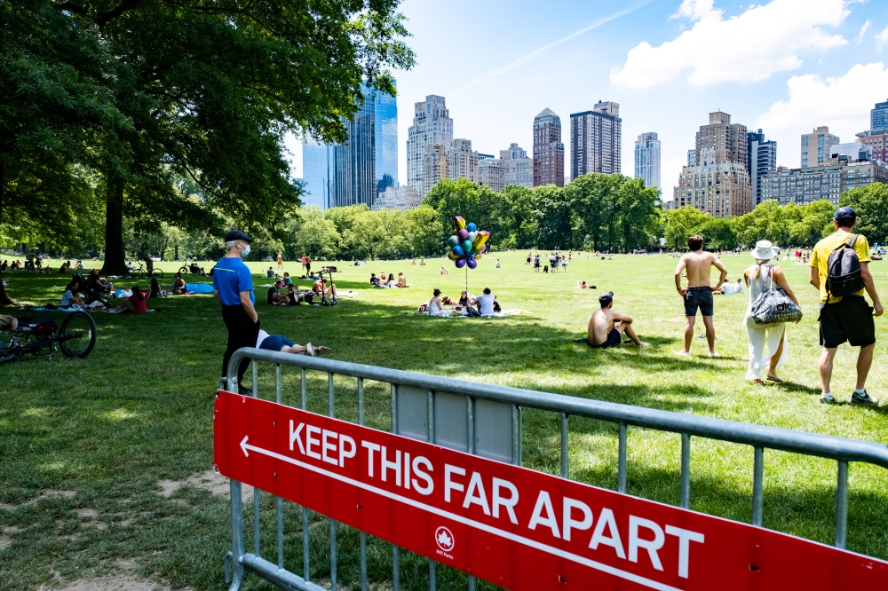 People enjoy the weather in Central Park, the day before the city starts phase two of reopening after the lockdown due to the coronavirus disease (COVID-19), in the Manhattan borough of New York City, U.S., June 21, 2020. REUTERS/Jeenah Moon
