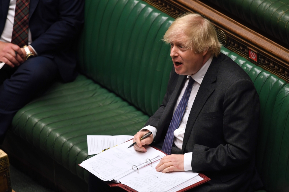 A handout photograph released by the UK Parliament shows Britain's Prime Minister Boris Johnson speaking during Prime Minister's Questions (PMQs) in the House of Commons in London on June 24, 2020. AFP PHOTO / Jessica Taylor /UK Parliament