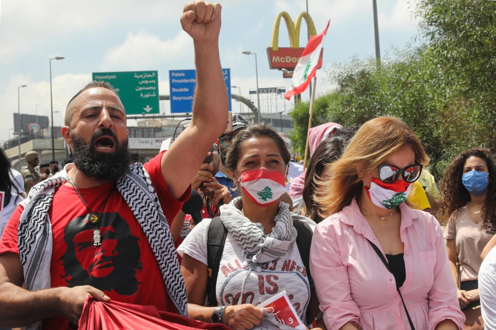 Lebanese anti-government protesters chant slogans as they take part in a demonstration near the presidential palace in Baabda, east of Beirut, on June 25, 2020. / AFP / ANWAR AMRO