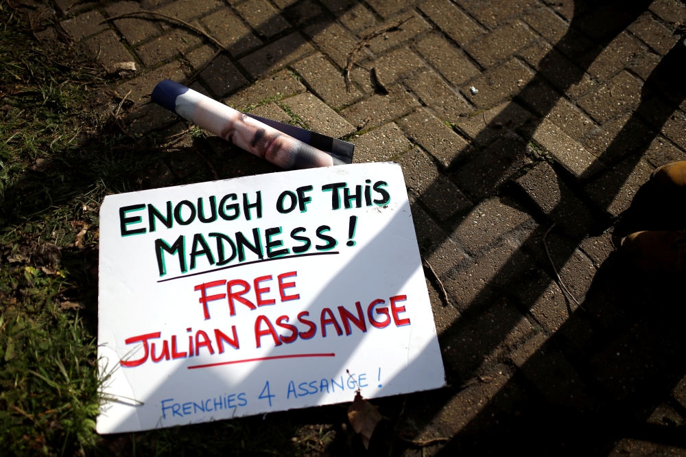 FILE PHOTO: A sign in support of WikiLeaks founder Julian Assange lies on the ground outside Woolwich Crown Court, ahead of a hearing to decide whether Assange should be extradited to the United States, in London, Britain February 25, 2020. REUTERS/Henry 