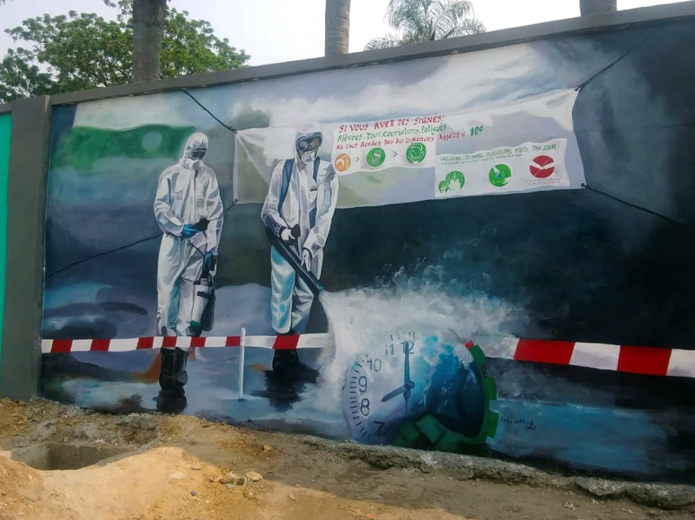 A wall mural depicts an advocacy message on fumigation as a measure against coronavirus disease (COVID-19) outbreak, on the walls of the Kinshasa Academy of Fine Arts in Kinshasa, Democratic Republic of Congo June 22, 2020. Picture June 22, 2020. REUTERS/