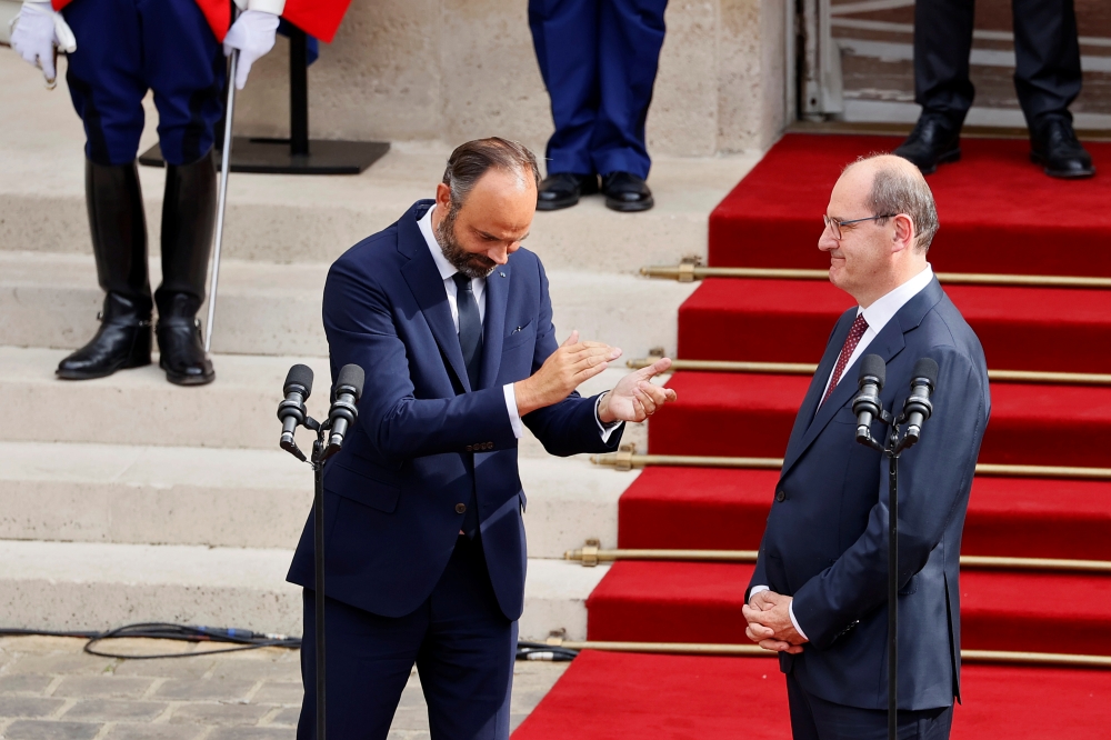 Former French Prime Minister Edouard Philippe applauds newly-appointed Prime Minister Jean Castex in the courtyard of the Matignon Hotel during the handover ceremony in Paris, France July 3, 2020. Thomas Samson/Pool via REUTERS